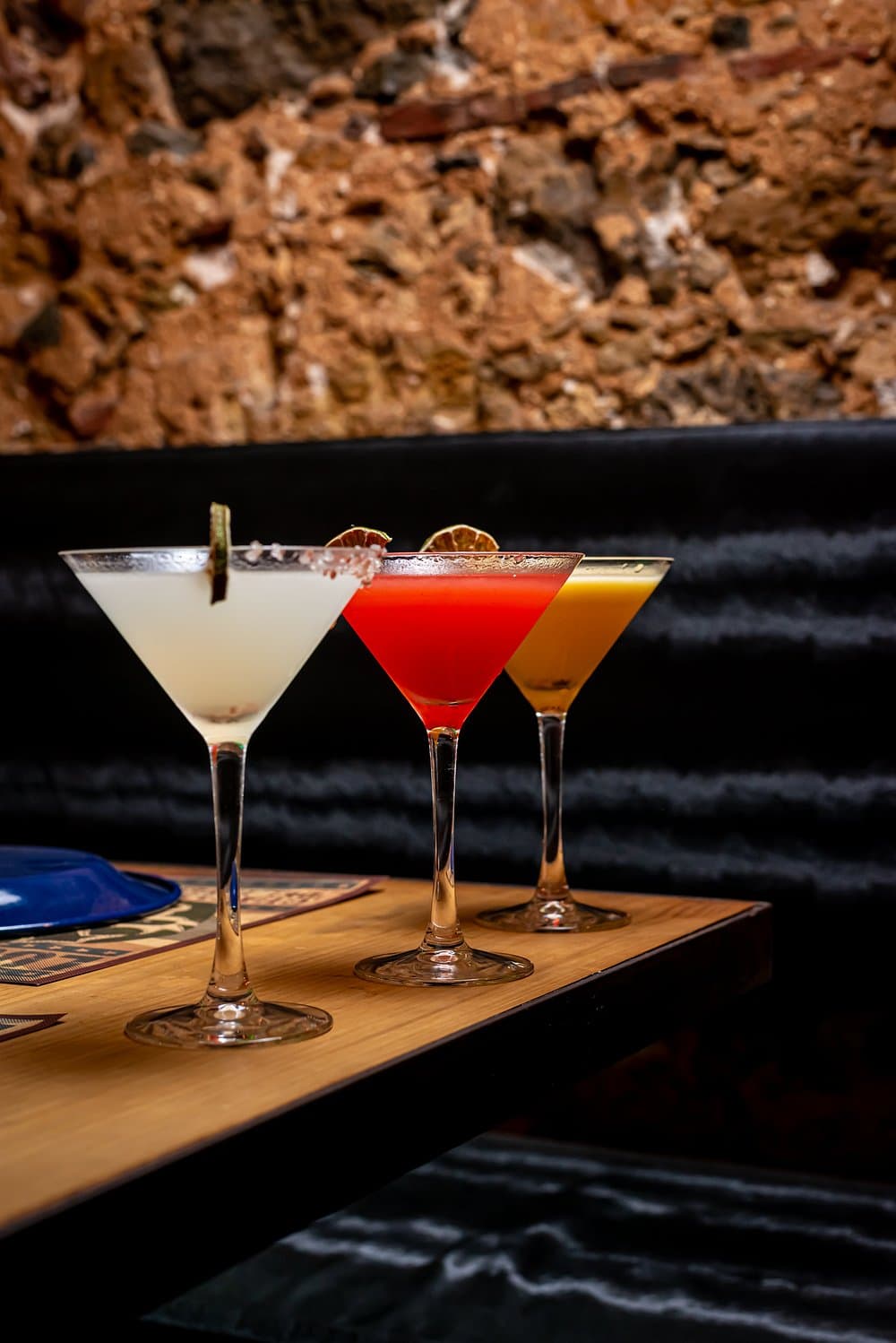 Three margaritas lined up on the bar at Las Ficheras